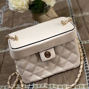 Quilted handbag with gold accents .